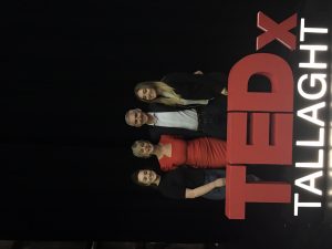 Barbara and family with TEDx signage